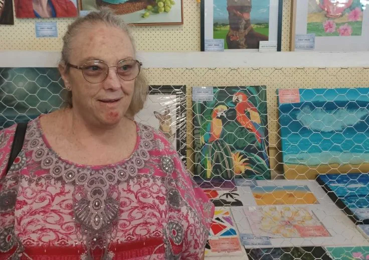 jennifer standing with one of her art works that won first prize.